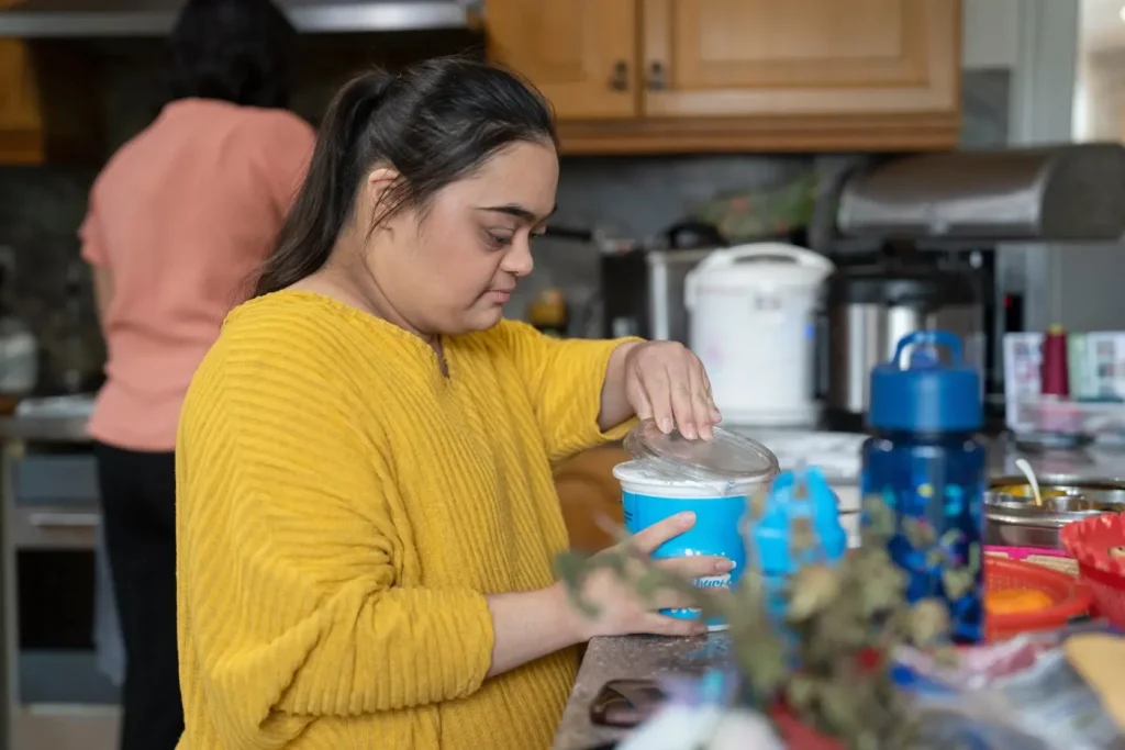 Indian girl with down syndrome making food in kitchen