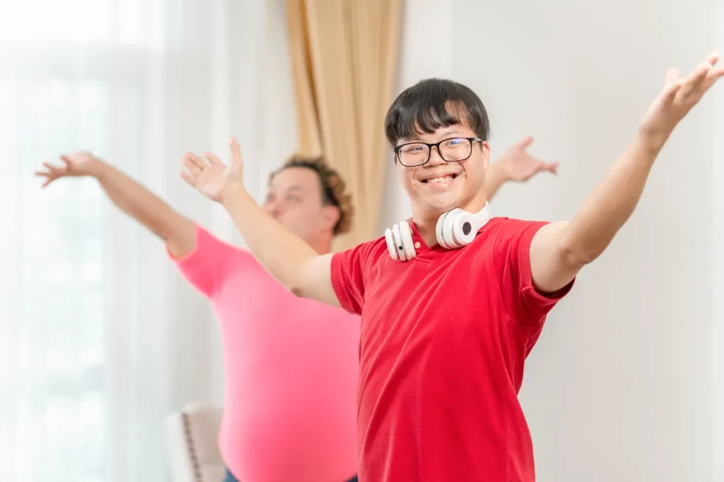 Two disabled friends dancing and smiling together at home