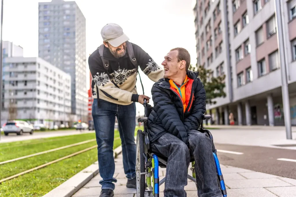 Disabled man in wheelchair with support worker